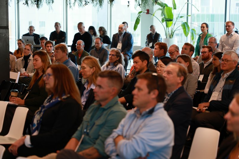 Summit attendees react to the end of a panel.