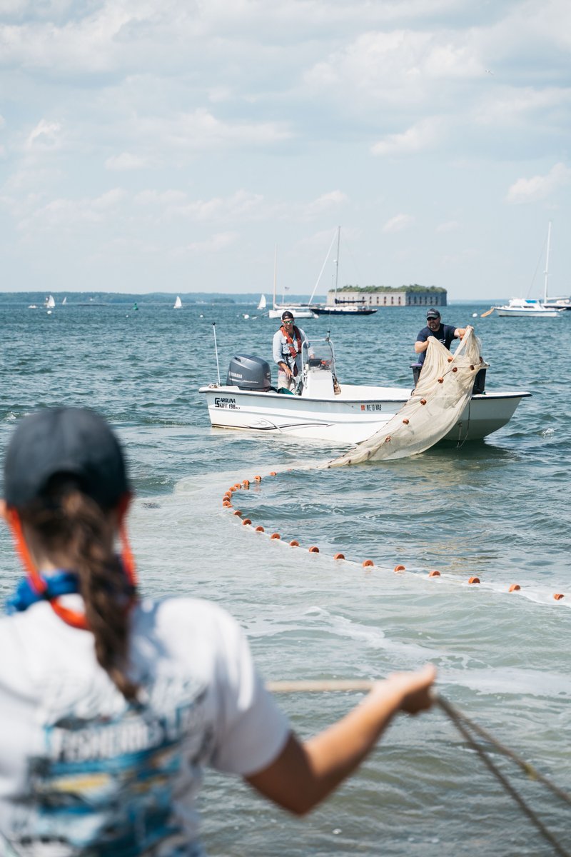 Three researchers using a skiff to seine in casco bay