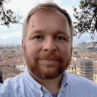 A portrait of a man smiling.