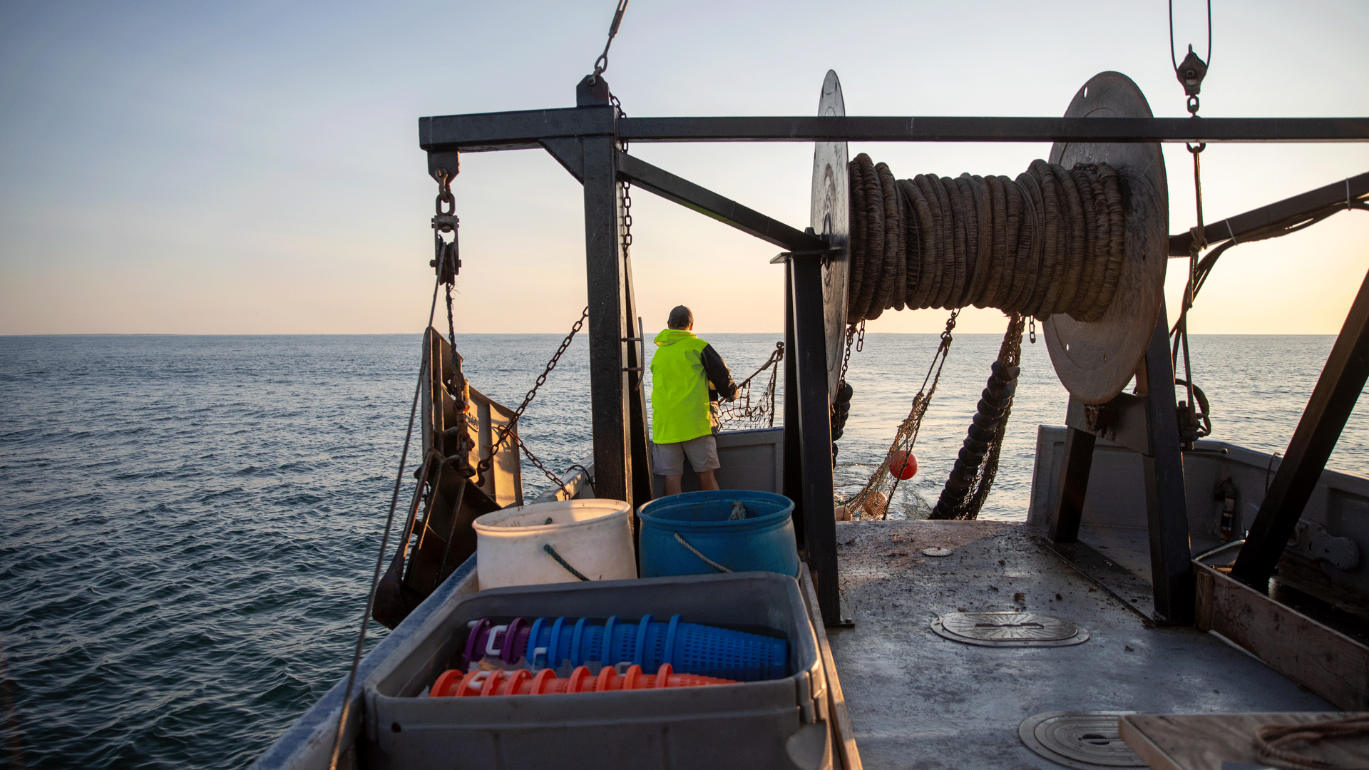 A fisherman releasing a trawling net.