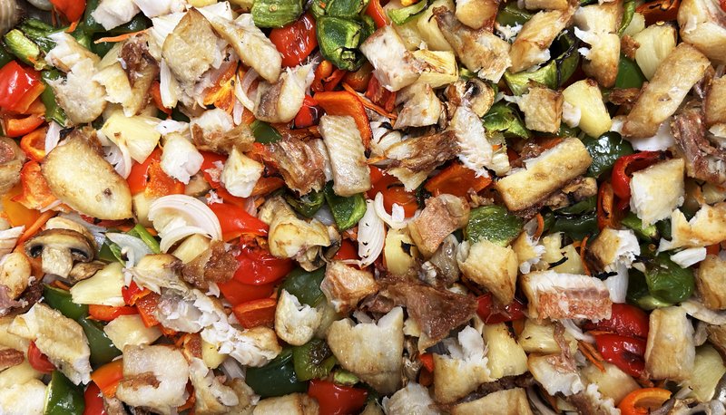 Beautiful school lunch made from fish, red and green peppers, and other vegetables.