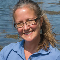 A portrait of a woman smiling.