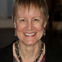 A portrait of a woman smiling.