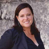 A portrait of a woman smiling.