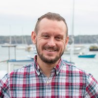 A portrait of a man smiling.