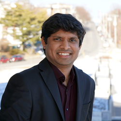 Portrait of Shishir smiling.