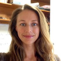 A portrait of a woman smiling.