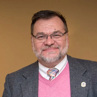 This is a portrait of a man smiling.