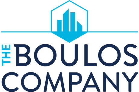 This is a logo for The Boulos Company, at the top of the graphic, a light blue line streaks across the image, with silhouetted skyscrapers in the center. The words "The Boulos Company" appear in darker colors at the bottom of the image.
