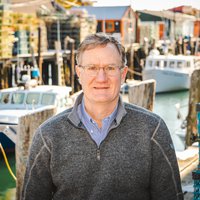 A portrait of a man smiling.
